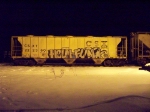 A CSX COVERED HOPPER CAR SITS IN MILLVILLE RAILROAD YARD ON A COLD WINTER'S NIGHT